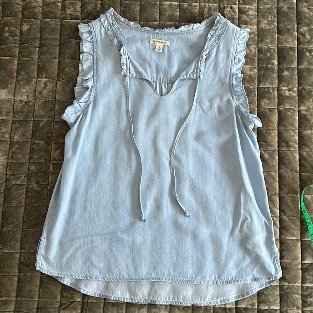 Sleeveless light blue top with ruffle trim